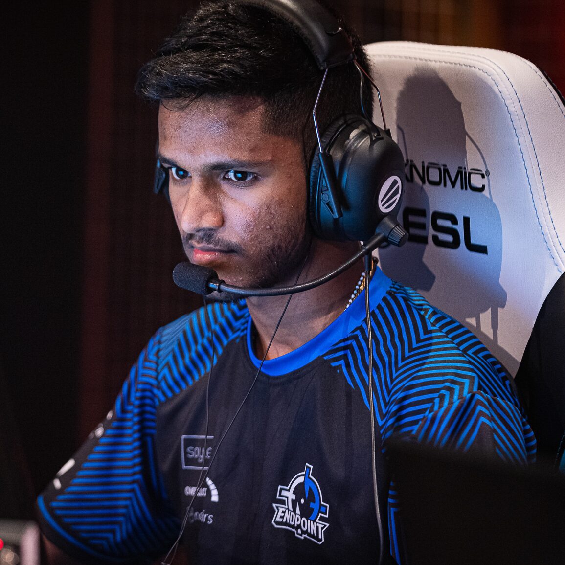 Tenstar's Russ with a headset on playing video games on stage