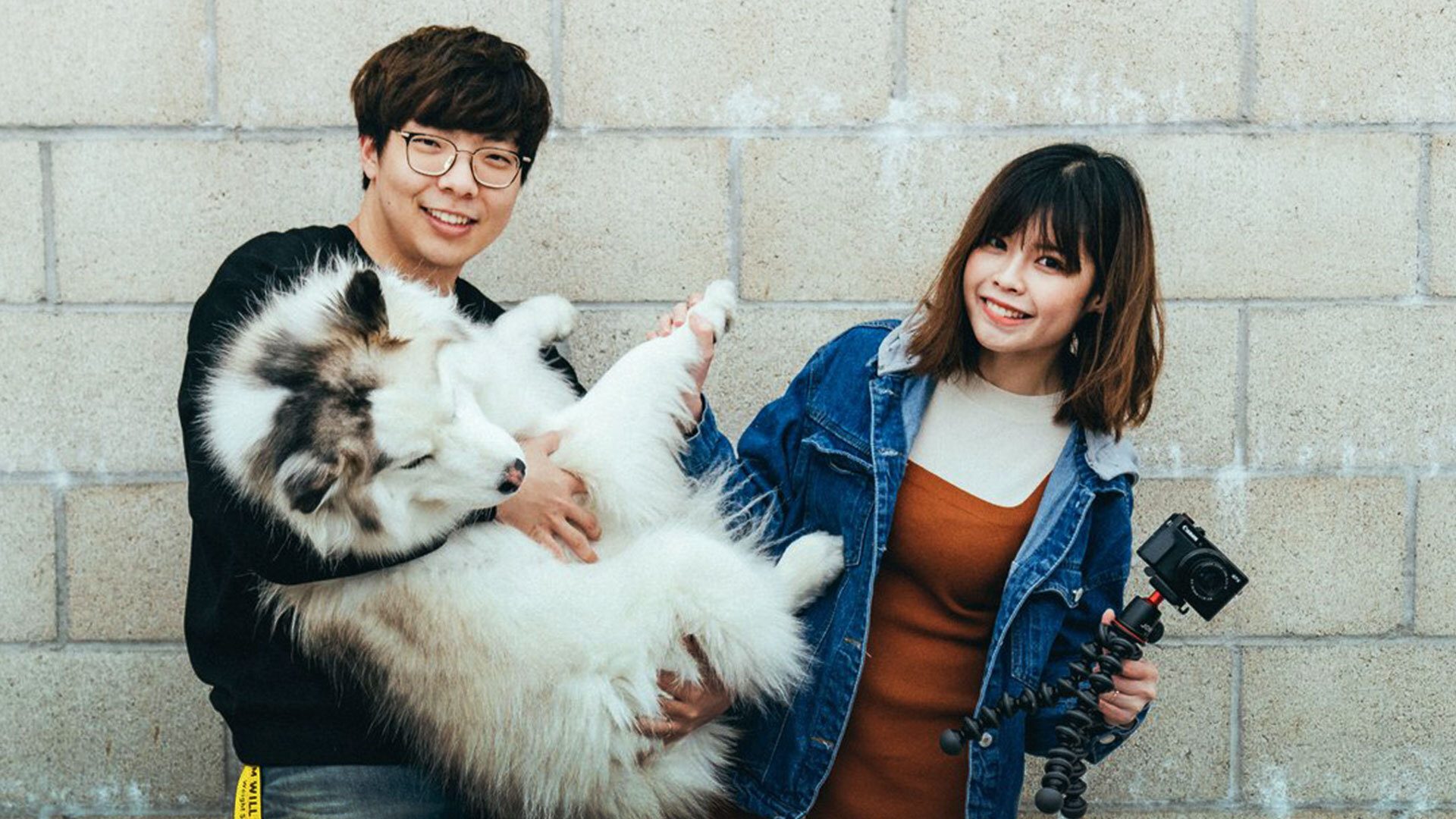 Huhi and Angela pose with their dog Haru for a picture.