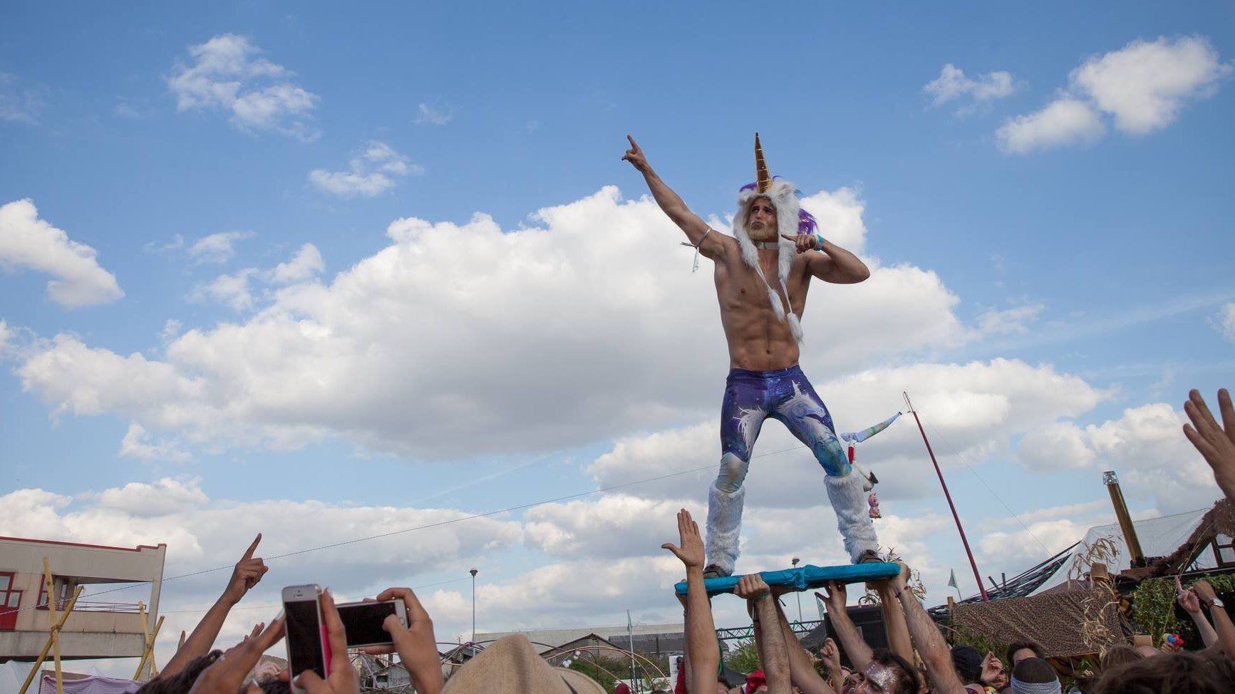 Romain Bigeard crowd surfing with a Unicorn hat