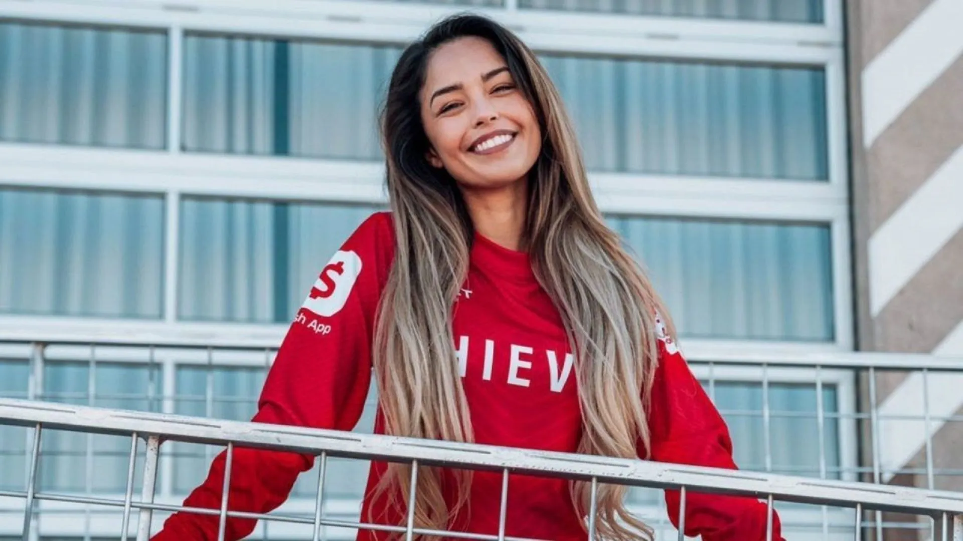 valkyrae standing on a balcony smiling