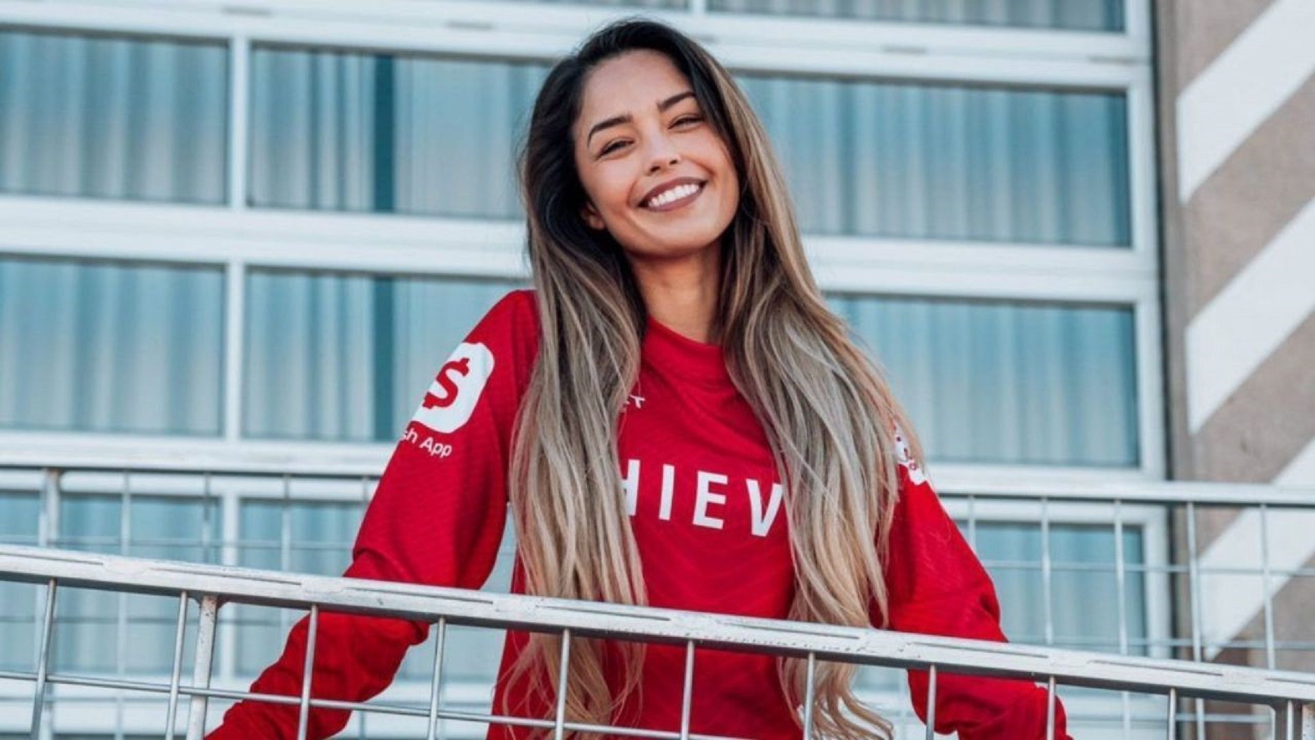 valkyrae standing on a balcony smiling