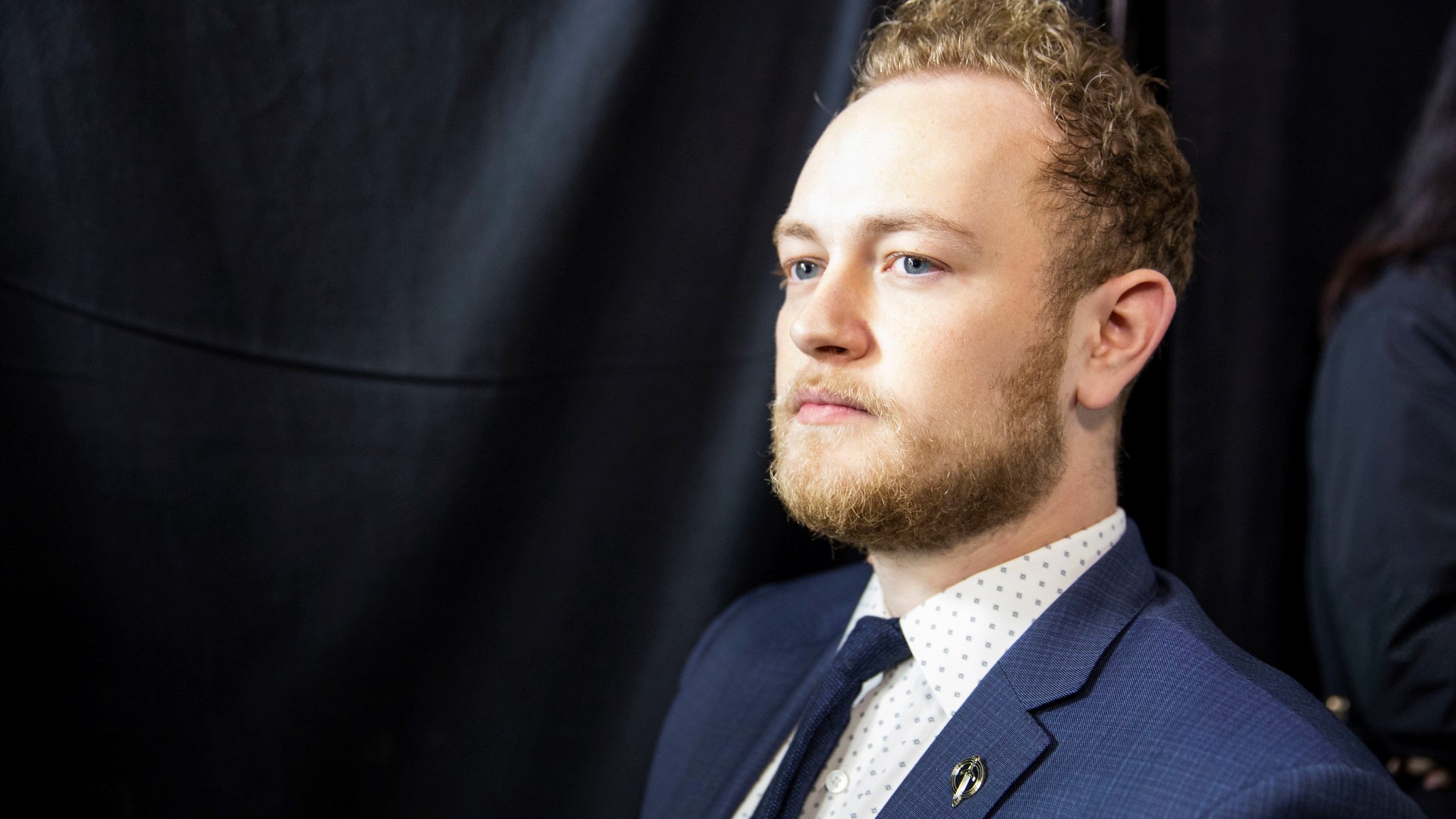 Golden Guardian's head coach headshot with the organization's pin in his lapel