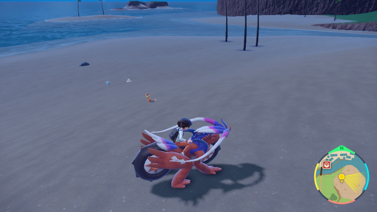 A Pokemon Scarlet and Violet player riding on top of the Pokemon Koraidon on the beach. Pokemon can be seen on the beach out in the wild, ready to be caught.