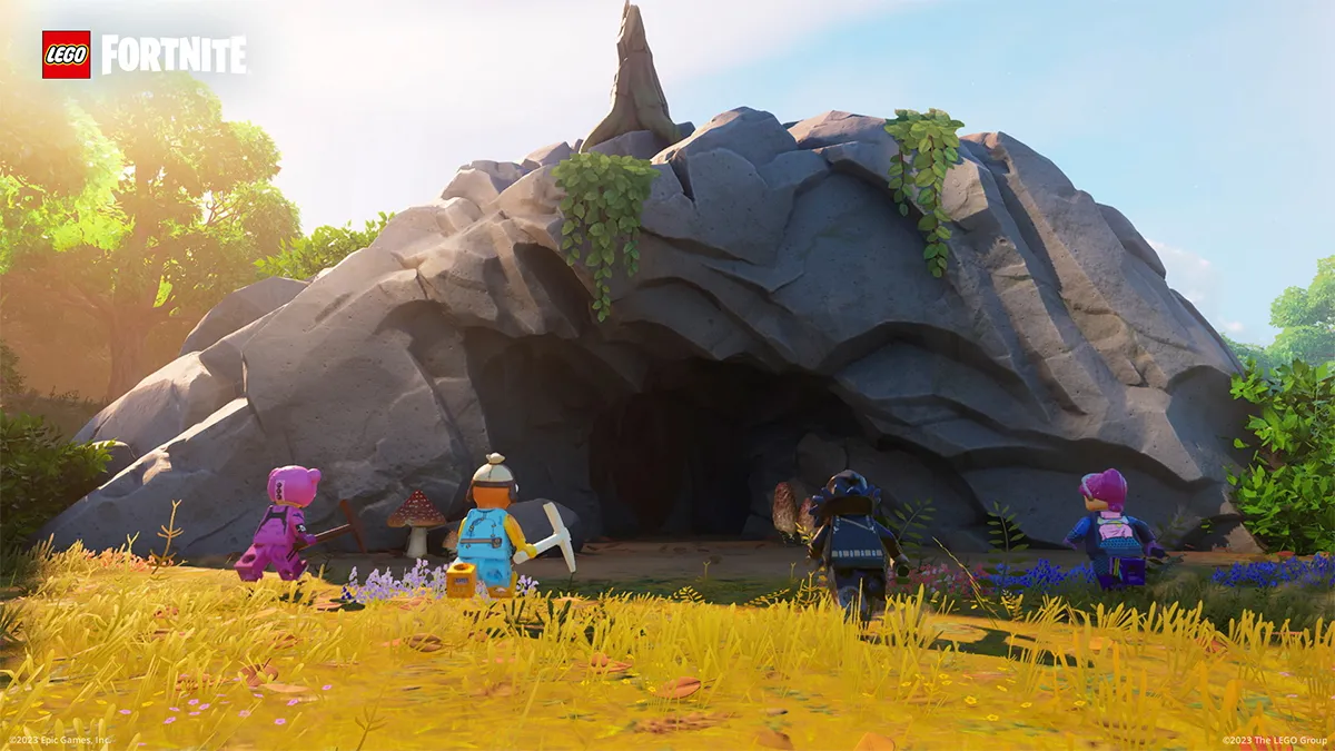 Four LEGO Fortnite characters running towards a cave.