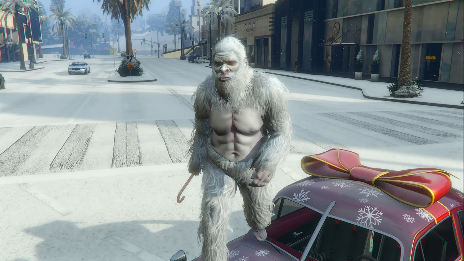 A GTA Online character in a Yeti custome on top of a red car wrapped like a present.