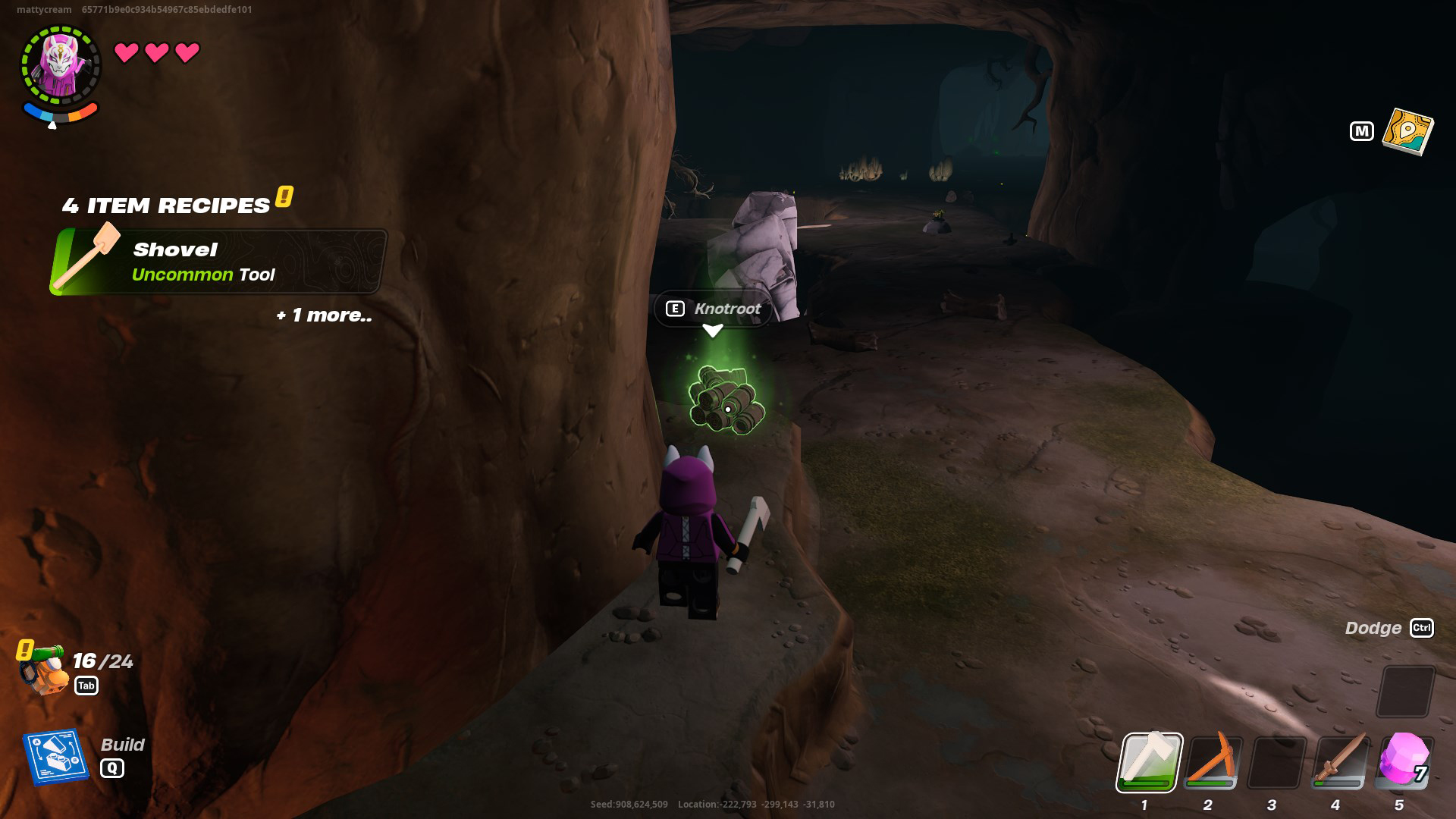 A LEGO Fortnite character, with an axe in their hand, looking at a pile of Knotroot Wood inside a cave. 