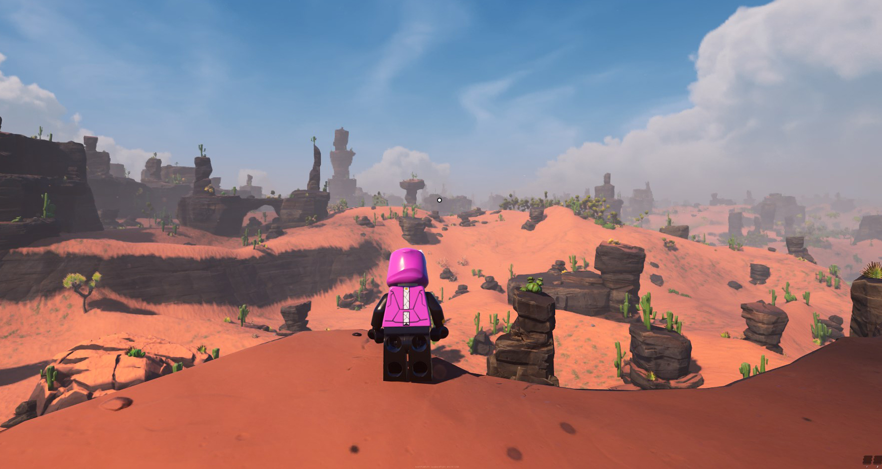 A LEGO Fortnite player standing on a mountain looking at a Dry Valley desert covered in rocks. 
