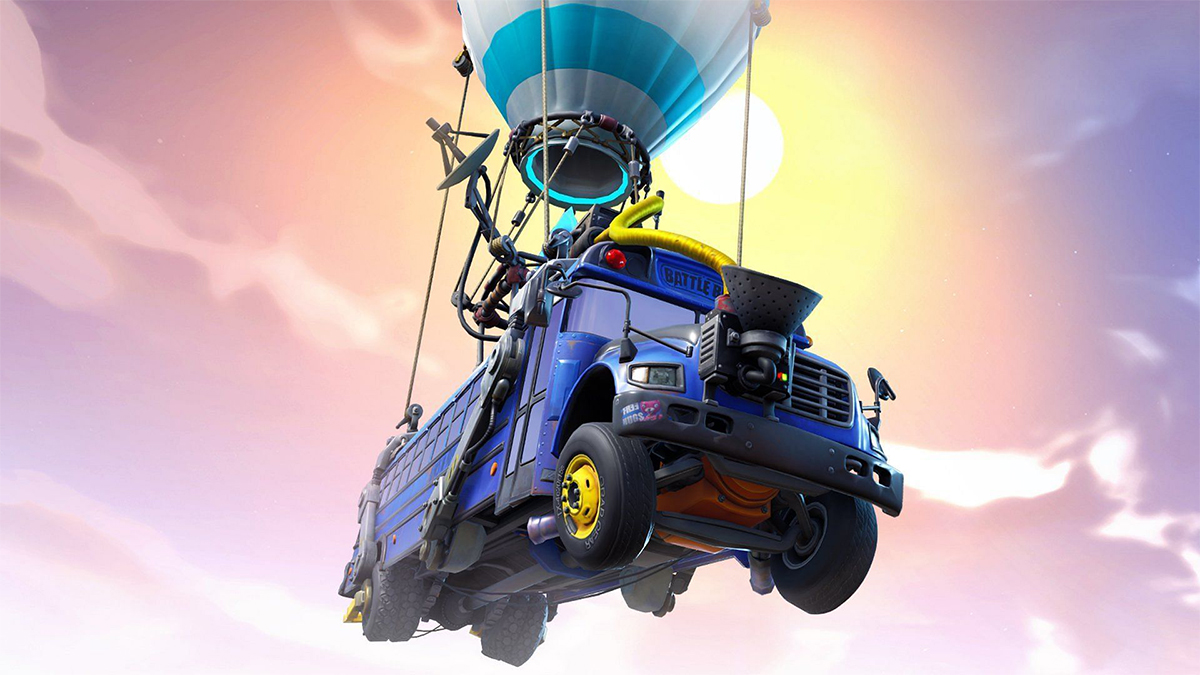 The Battle Bus, a blue bus with a white hot air balloon strapped to it, flying in front of the sun.