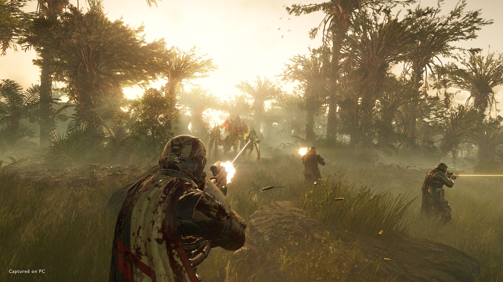 A team of players in Helldivers 2 shooting at an enemy creature. 