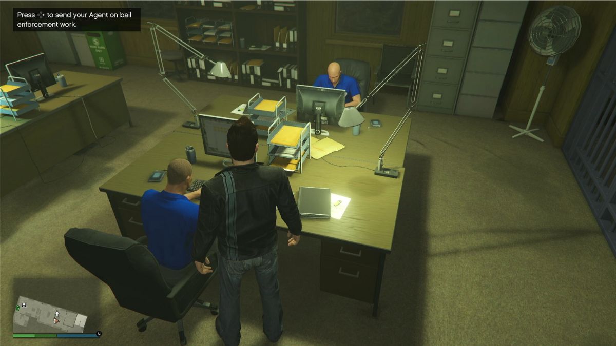 The Bottom Dollar Bounties agents sitting at their desks in the bail office. 