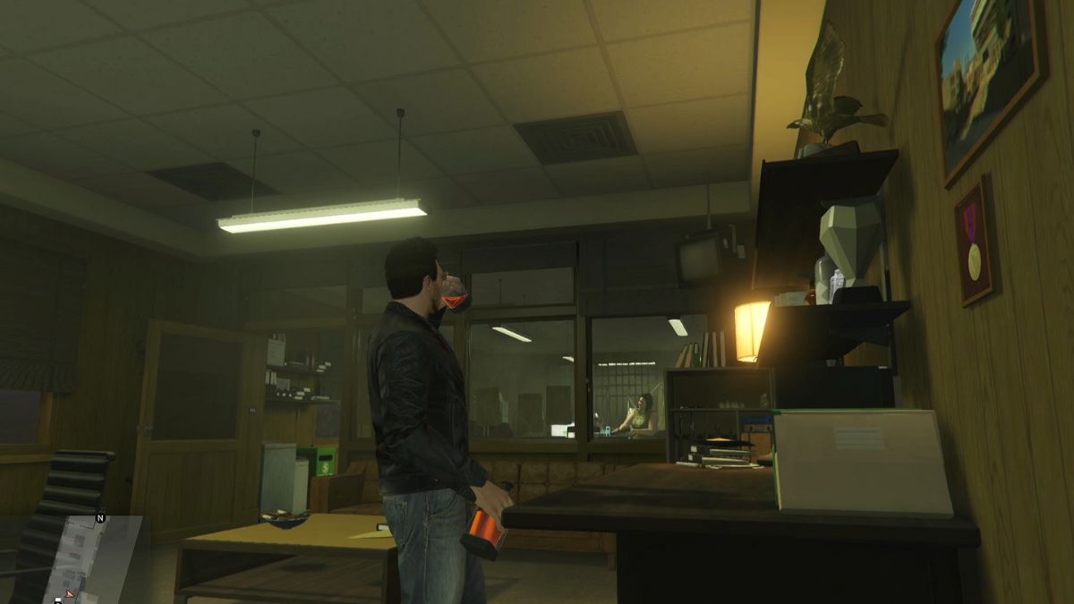 GTA Online player having a drink in the bail office.