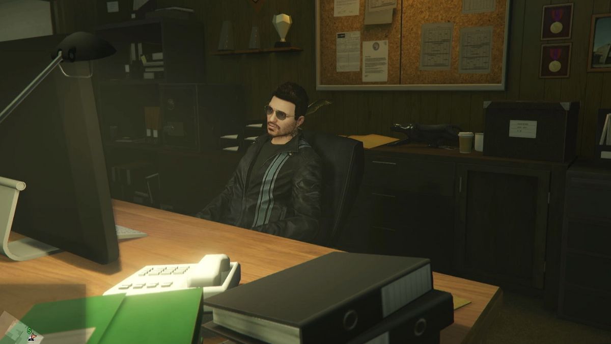 Player sitting at the main desk in the bail office from the Bottom Dollar Bounties DLC for GTA Online.