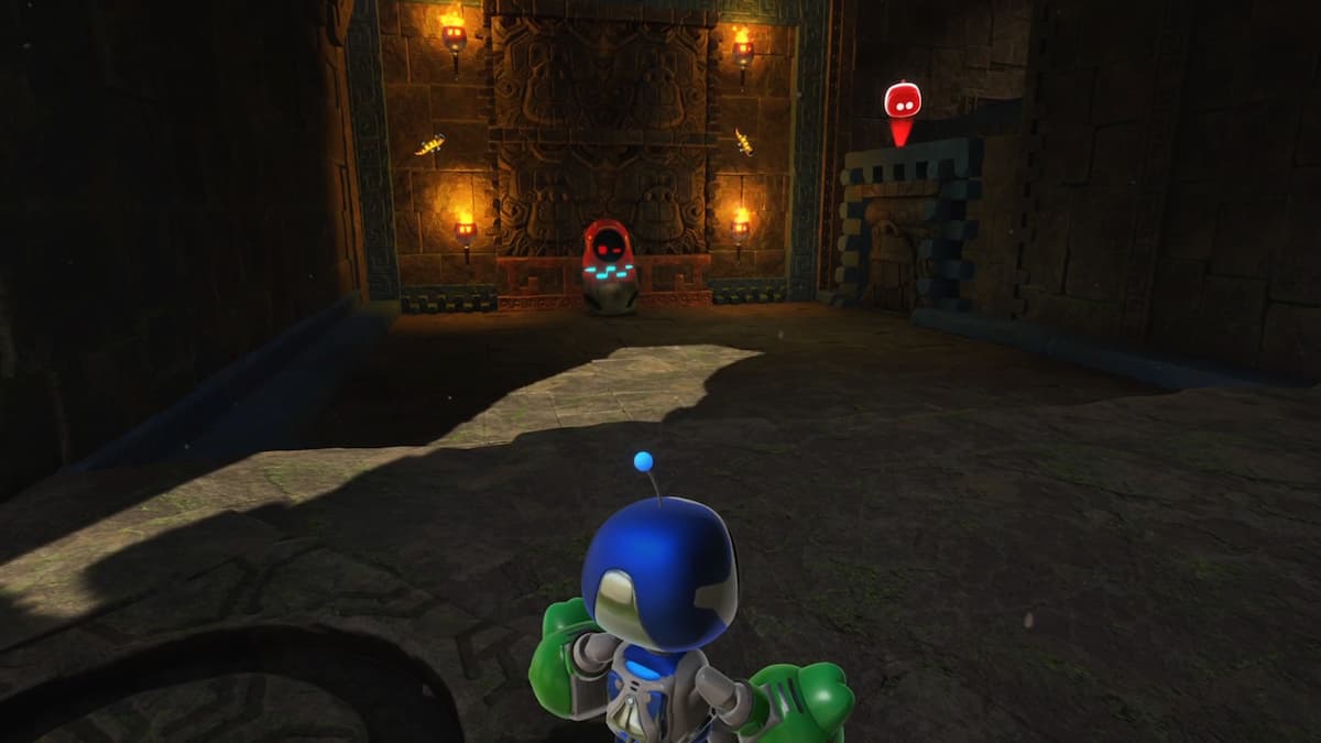 Astro Bot stands in a dark Aztec-themed room with a Russian doll bot at the center, surrounded by glowing torches and ancient stone carvings.