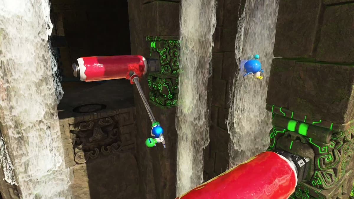 Astro Bot uses green twin-frog gloves to swing from stone columns with glowing green carvings in a waterfall area.