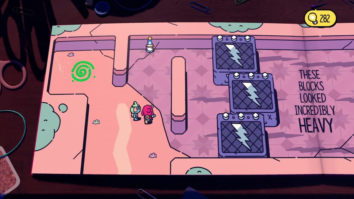 Two characters standing near large blocks with lightning symbols in The Plucky Squire game. The blocks look incredibly heavy, with a green portal nearby.