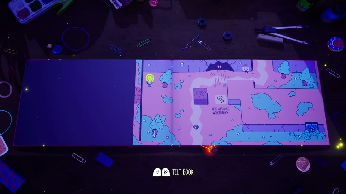 Una vista amplia del diseño del rompecabezas tipo libro que presenta un obstáculo de bloques de madera y enemigos ocultos en un entorno de libro de cuentos.